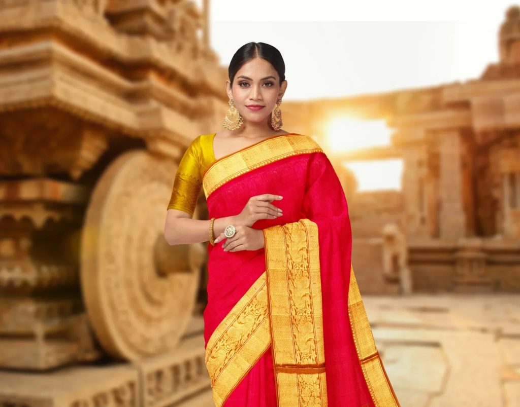 A woman wears a traditional Indian silk saree in vibrant red, a symbol of grace.
